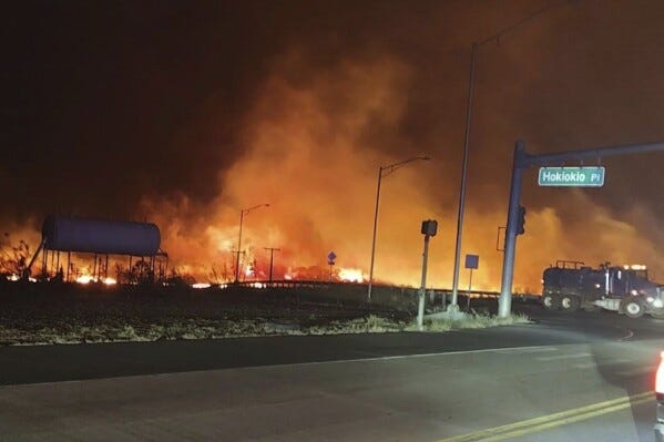 This photo provided by County of Maui shows fire and smoke filling the sky from wildfires on the intersection at Hokiokio Place and Lahaina Bypass in Maui, Hawaii on Tuesday, Aug. 8, 2023. 