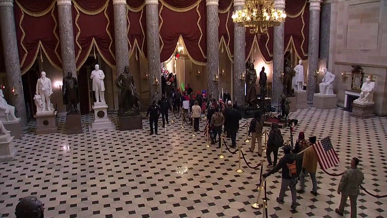 Protestors walk through Statuary Hall toward the House chamber in the U.S. Capitol Protestors walk through Statuary Hall toward the House chamber in the U.S. Capitol
