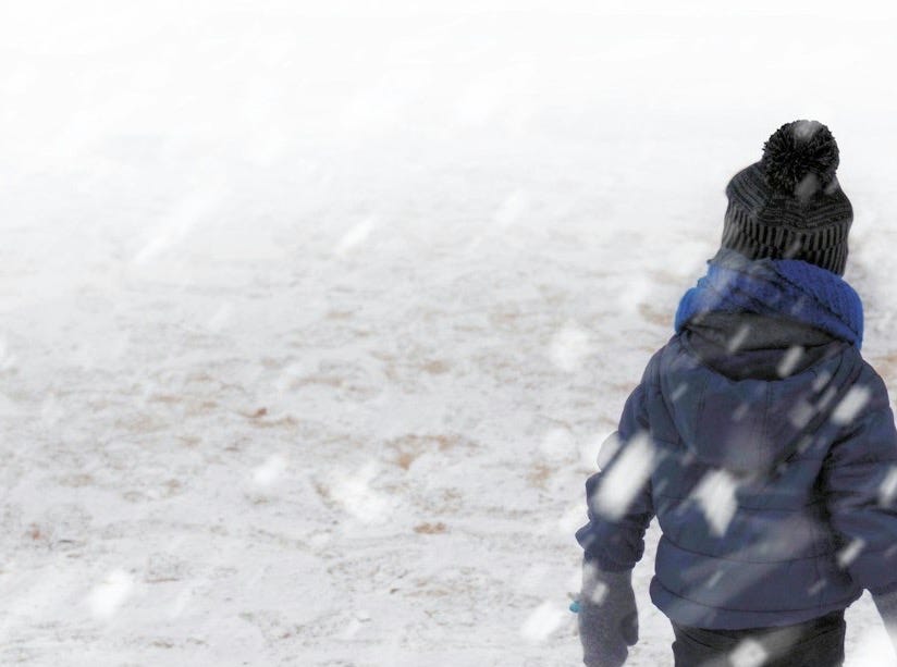 child in blue coat walking on snow field child in blue coat walking on snow field
