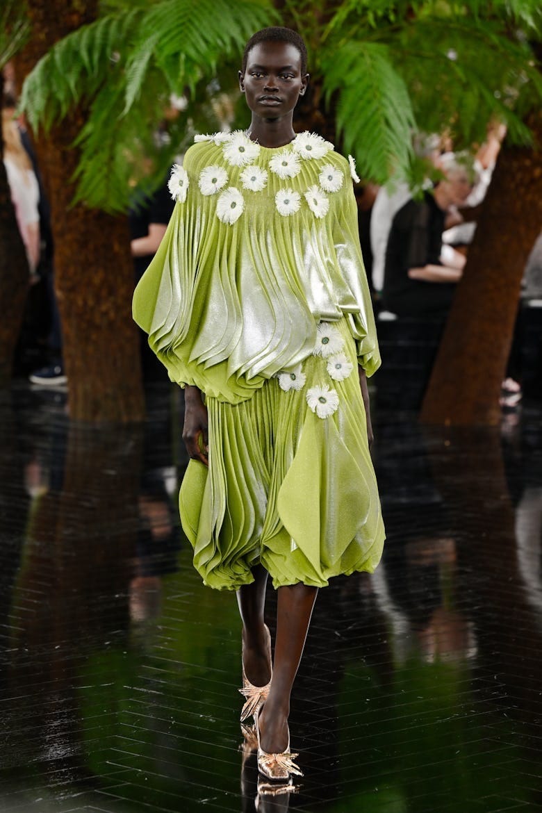 Model wearing a chartreuse pleated floral look from Dior’s Fall 2026 ready-to-wear collection.