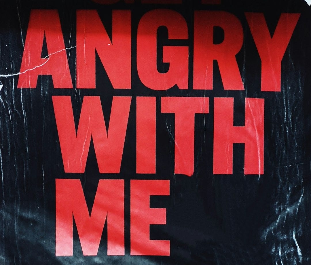 an angry with me sign on a wall