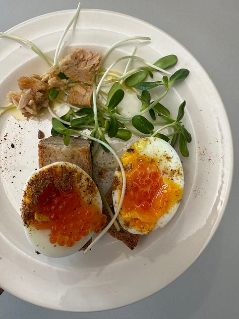 A combination of roast vegetables, tinned fish, greens, eggs, tortillas and sauce
