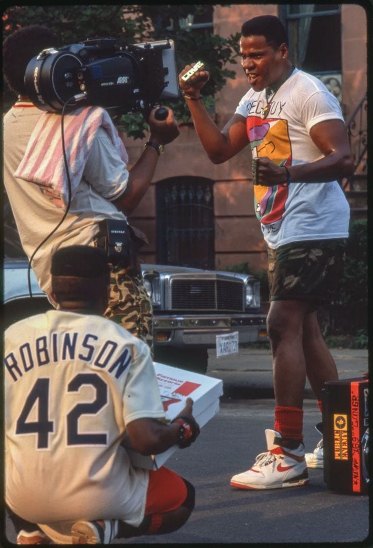 This may contain: two men are filming another man on the street This may contain: two men are filming another man on the street