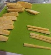 A cutting board with cut up pineapples

AI-generated content may be incorrect.