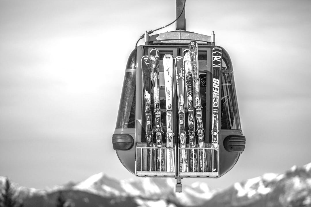 selective focus photography of ski blades on blue cable car selective focus photography of ski blades on blue cable car