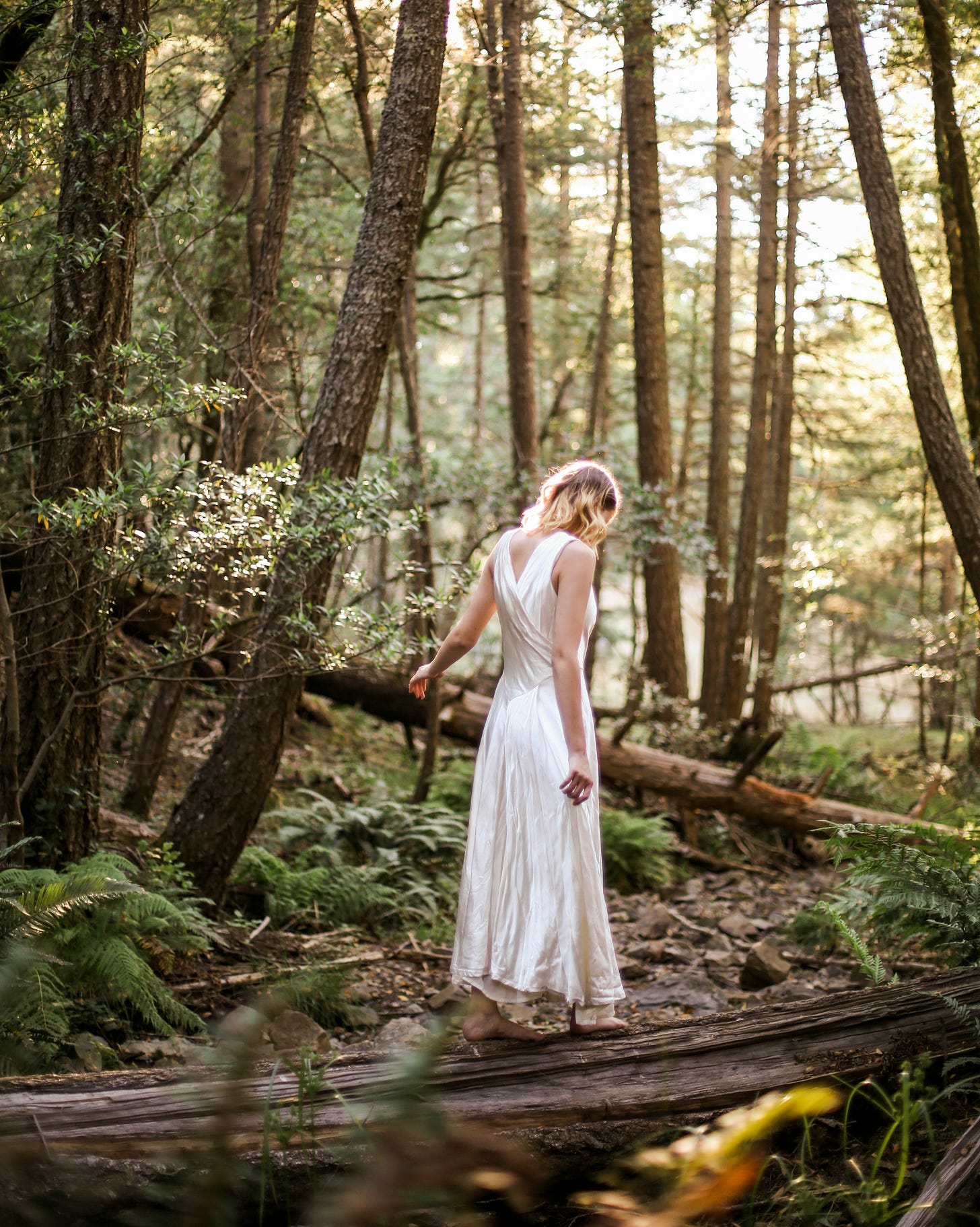 woman-in-white-dress-standing-on-forest-during-daytime