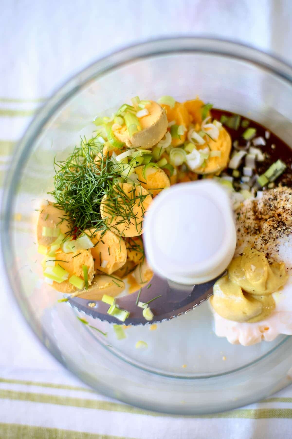 a food processor with deviled egg ingredients inside.