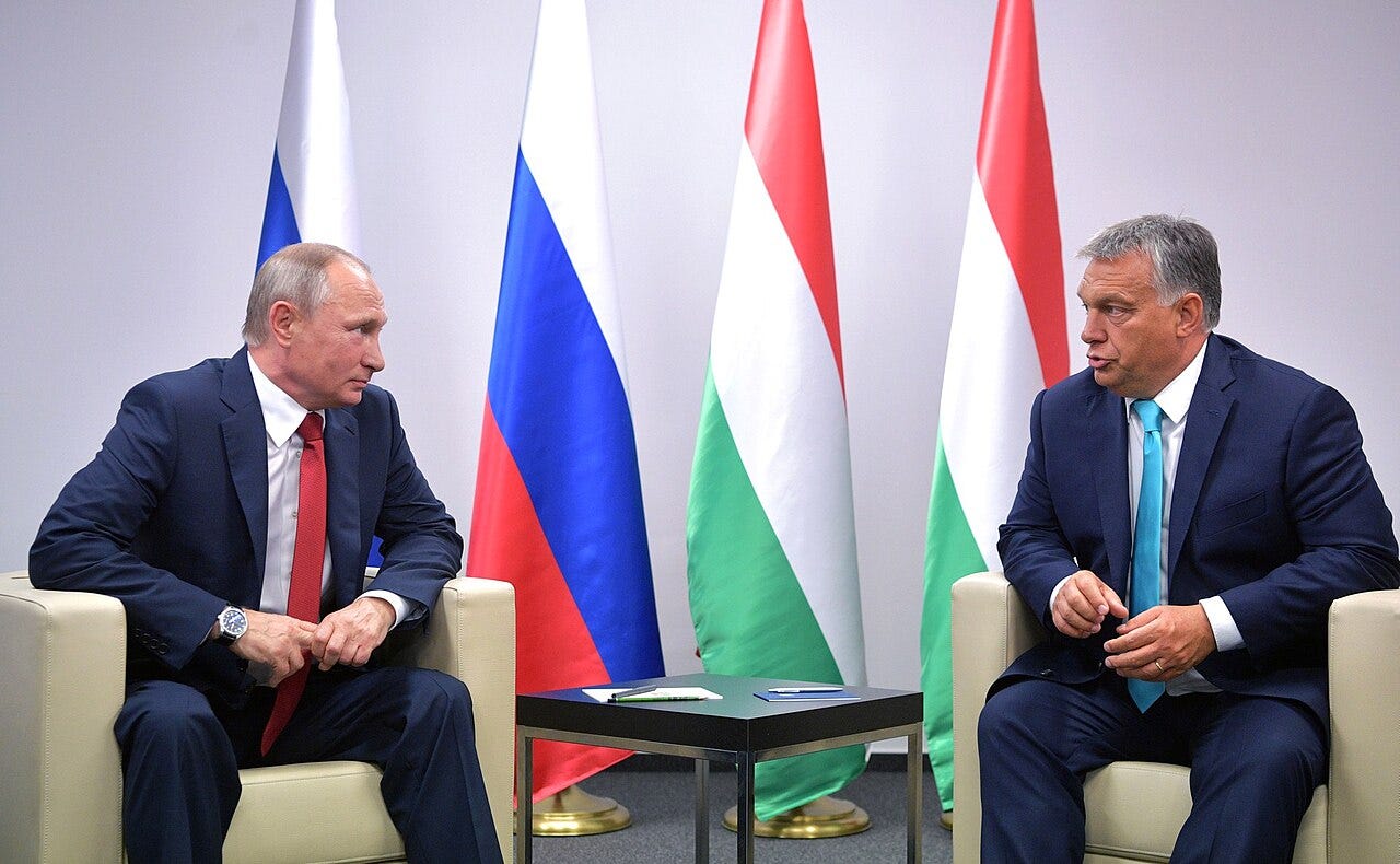 Viktor Orbán and Vladimir Putin meeting in Budapest in 2017, standing in front of Hungarian and Russian flags Viktor Orbán and Vladimir Putin meeting in Budapest in 2017, standing in front of Hungarian and Russian flags