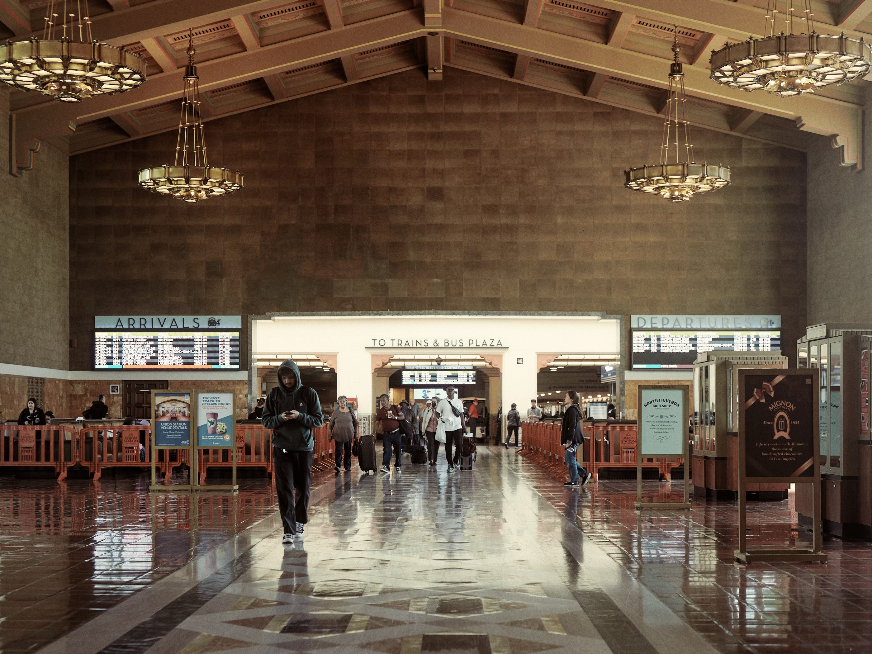 People crowding at the indoor main entrance plaza of Union Station in Los Angeles. Photographed by LA photographer Afonso Salcedo.