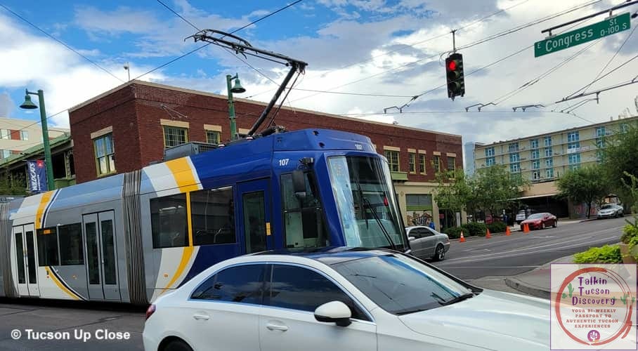 public street car electrically powered traveling through a main city street