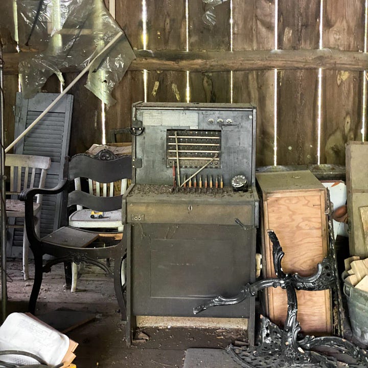 Treasures found in the old barn. Vintage toys, an old trunk, wooden chairs, an old telephone operator.