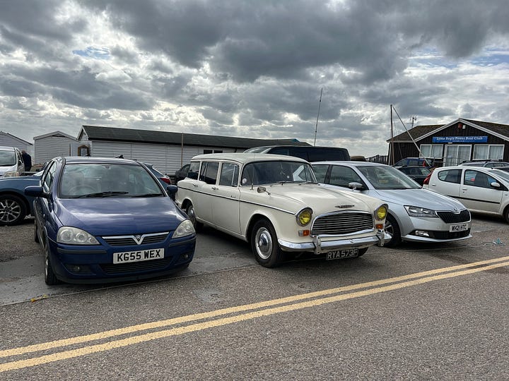 Photo 1 a 1967 Dark Blue E-Type Jaguar in a car park in Lyme Regis. Photo 2 a 1968 Humber Hawk IVA in a Lyme Regis Car Park. Images: Roland's Travels