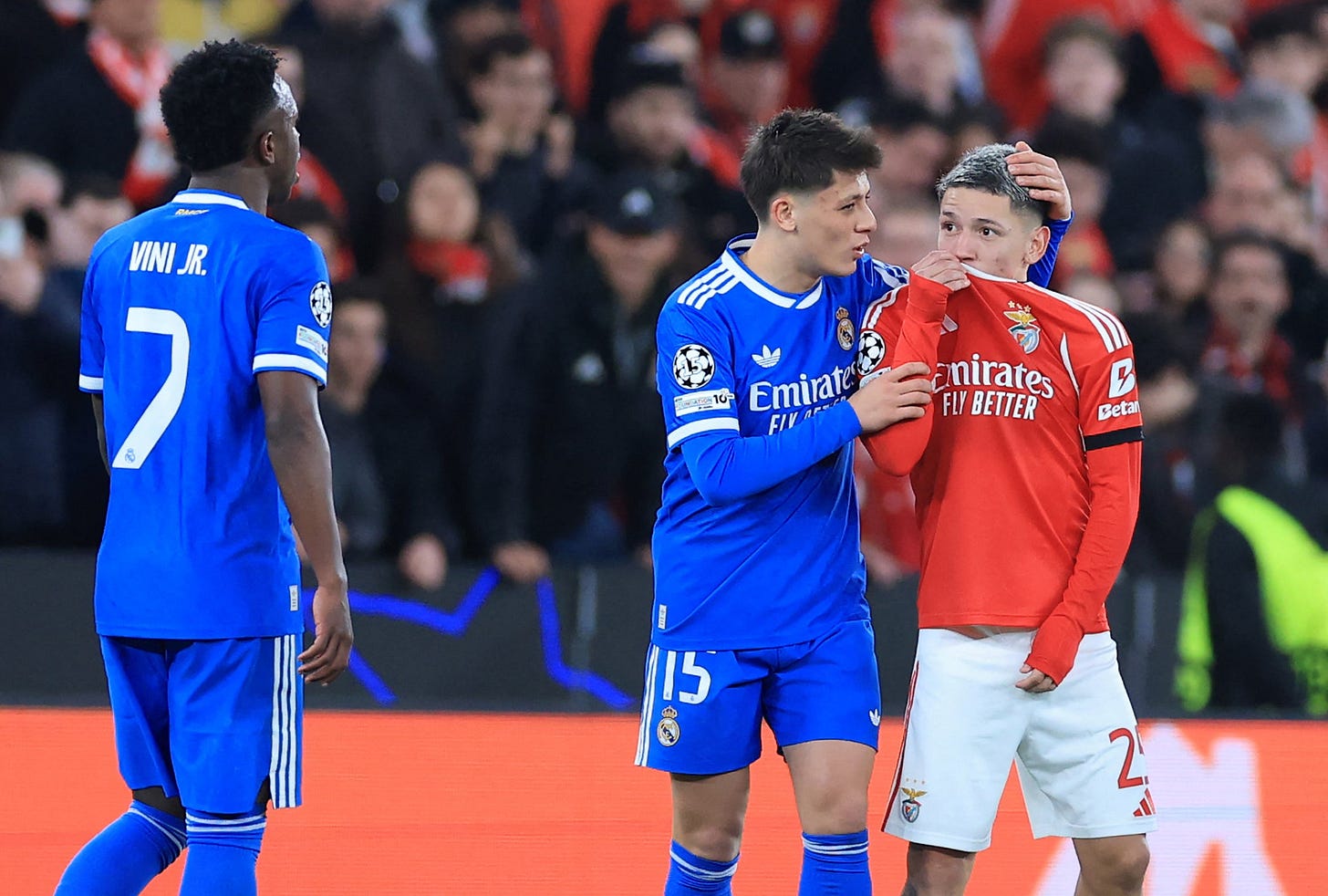 Gianluca Prestianni hides his mouth while arguing with Real Madrid's Vinicius Junior
