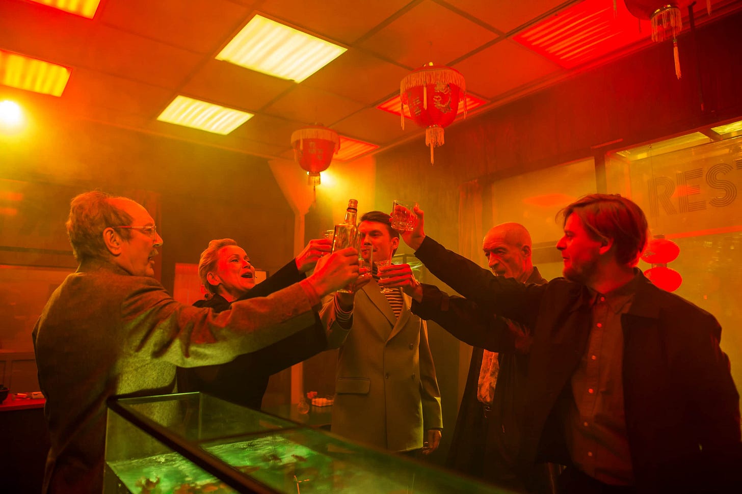 A group of people raise a toast in a Chinese restaurant.