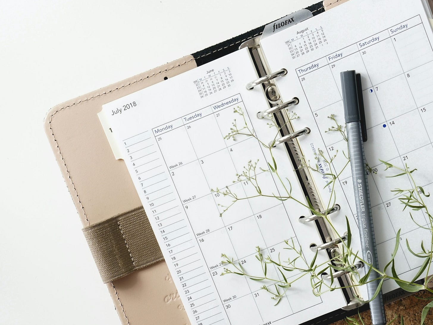 grey and black pen on calendar book grey and black pen on calendar book