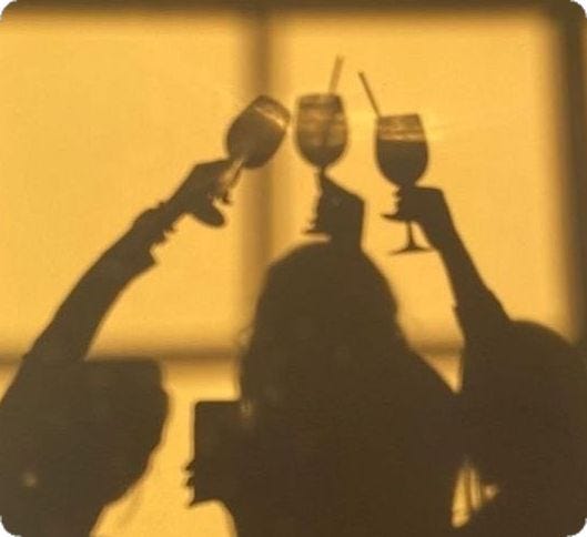 This may contain: two people holding up wine glasses in the air