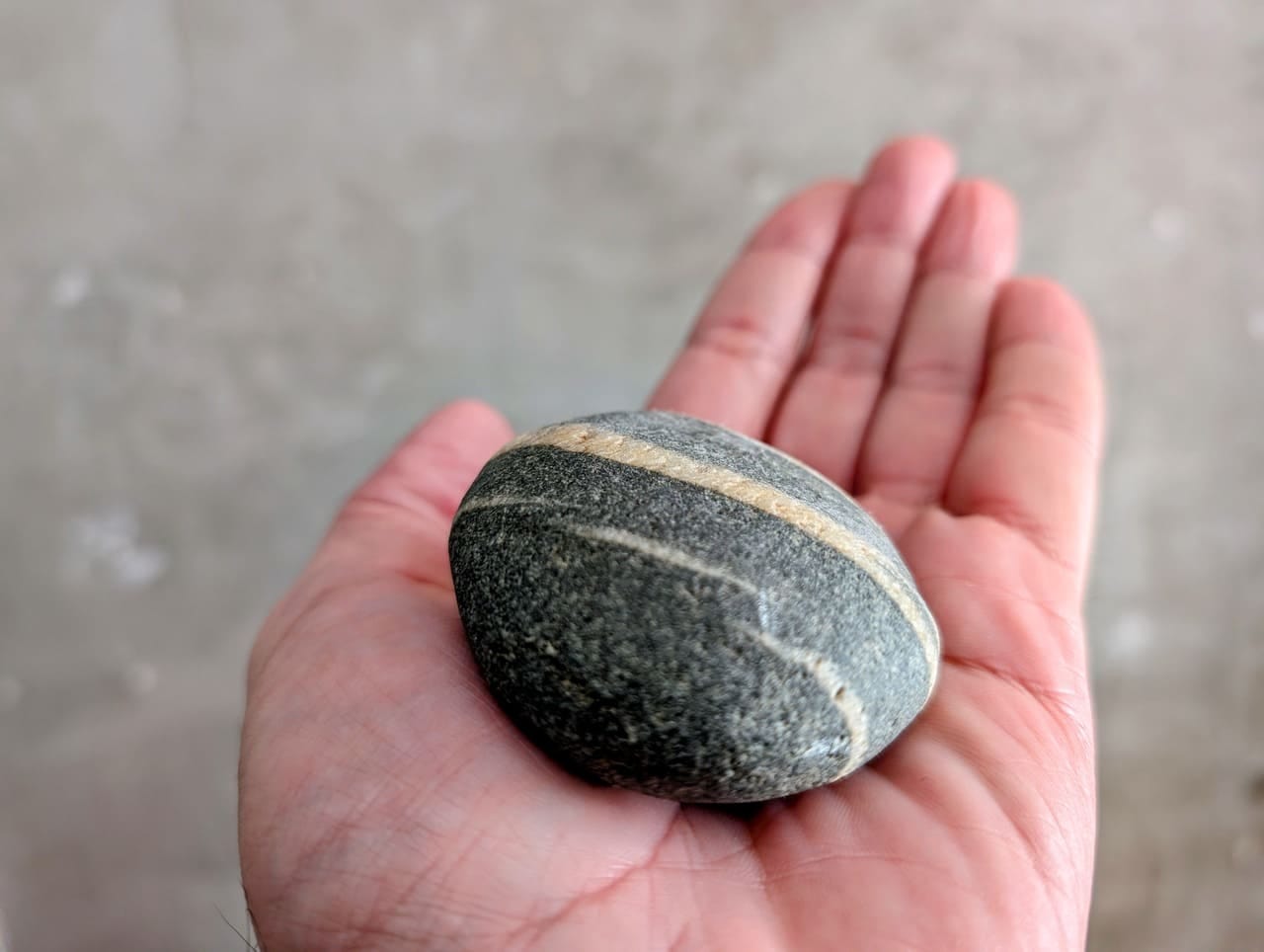 Large stone in the palm of a hand