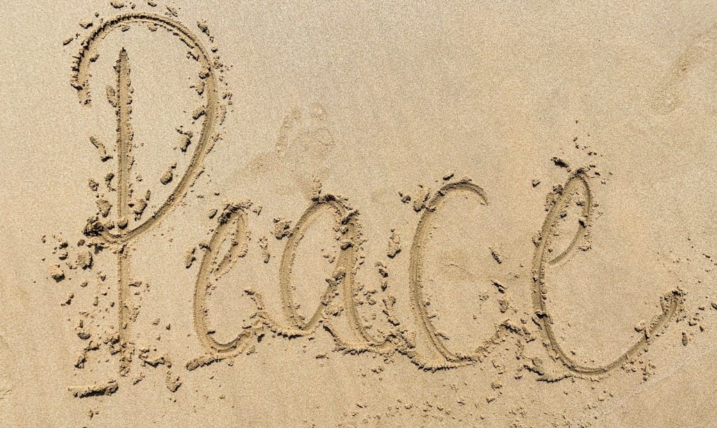 heart drawing on white sand