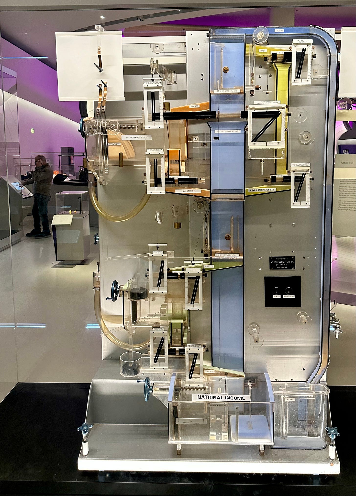 The Phillips machine, also known as the MONIAC (Monetary National Income Analogue Computer), an analogue computation device using water and tanks of varying size to model a holistic view of the British economy, taken at the Science Museum. The Phillips machine, also known as the MONIAC (Monetary National Income Analogue Computer), an analogue computation device using water and tanks of varying size to model a holistic view of the British economy, taken at the Science Museum.