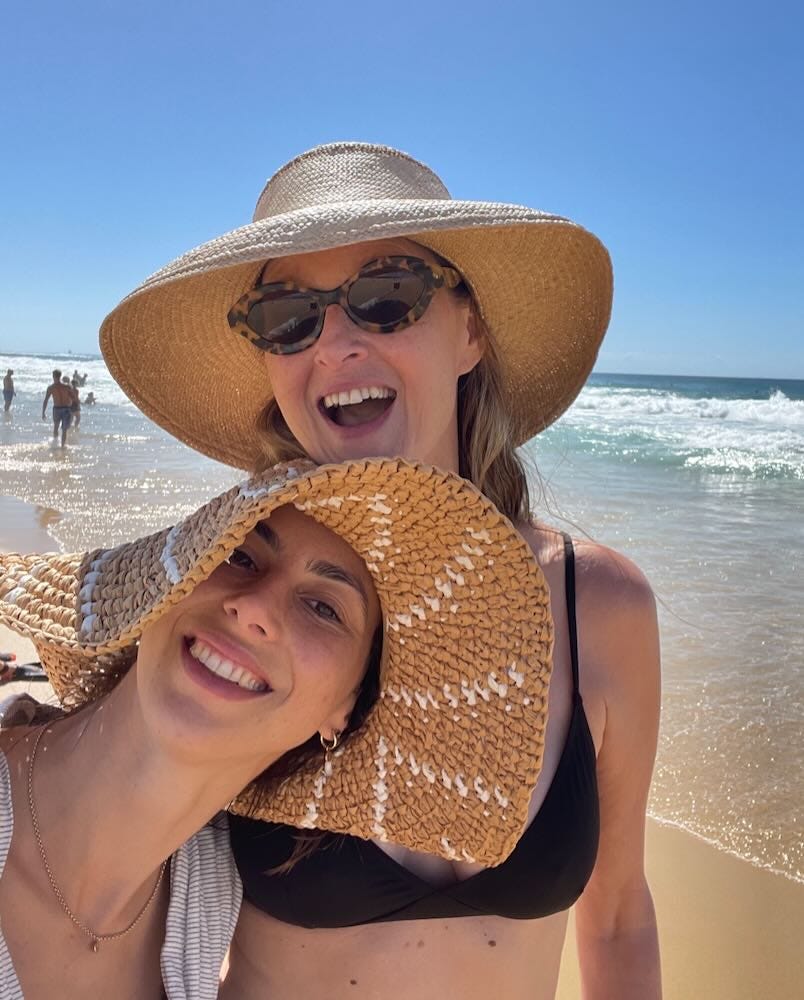 mother and daughter laughing on the beach mother and daughter laughing on the beach