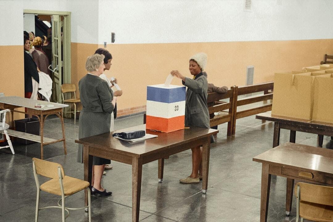 A young African American woman casting her ballot in 1964 A young African American woman casting her ballot in 1964