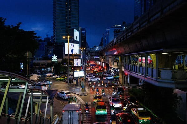 A city street at night, dense with traffic.