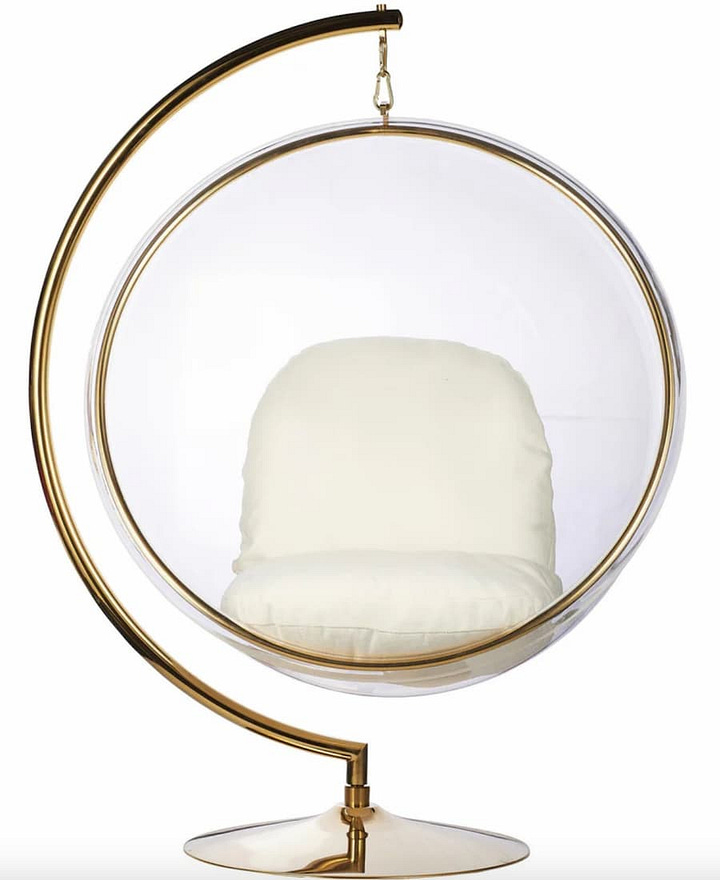 bubble chairs, on standing and one hanging with cream seated cushioj