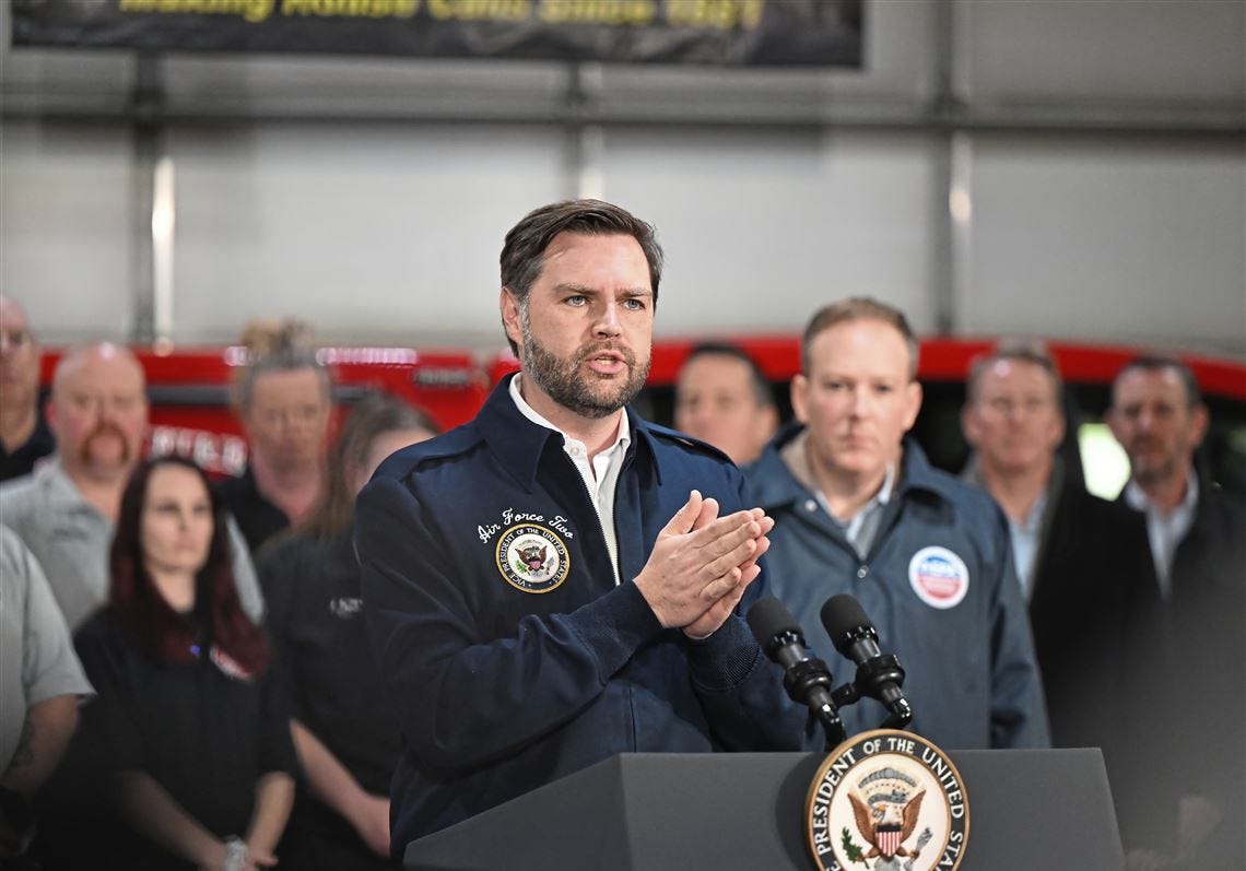 Vice President JD Vance speaking at a podium with the presidential seal, people standing behind him. 