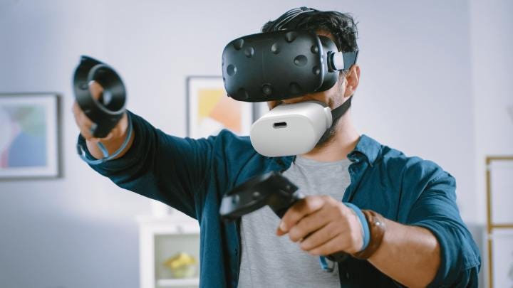 A VR user wears the Mutalk microphone.