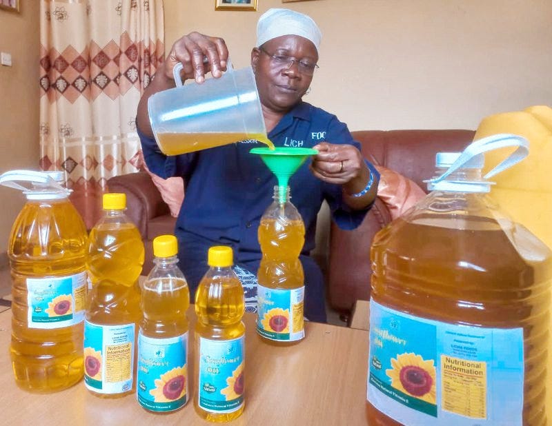 Marystella Wabwoba packaging sunflower oil in branded bottles Marystella Wabwoba packaging sunflower oil in branded bottles