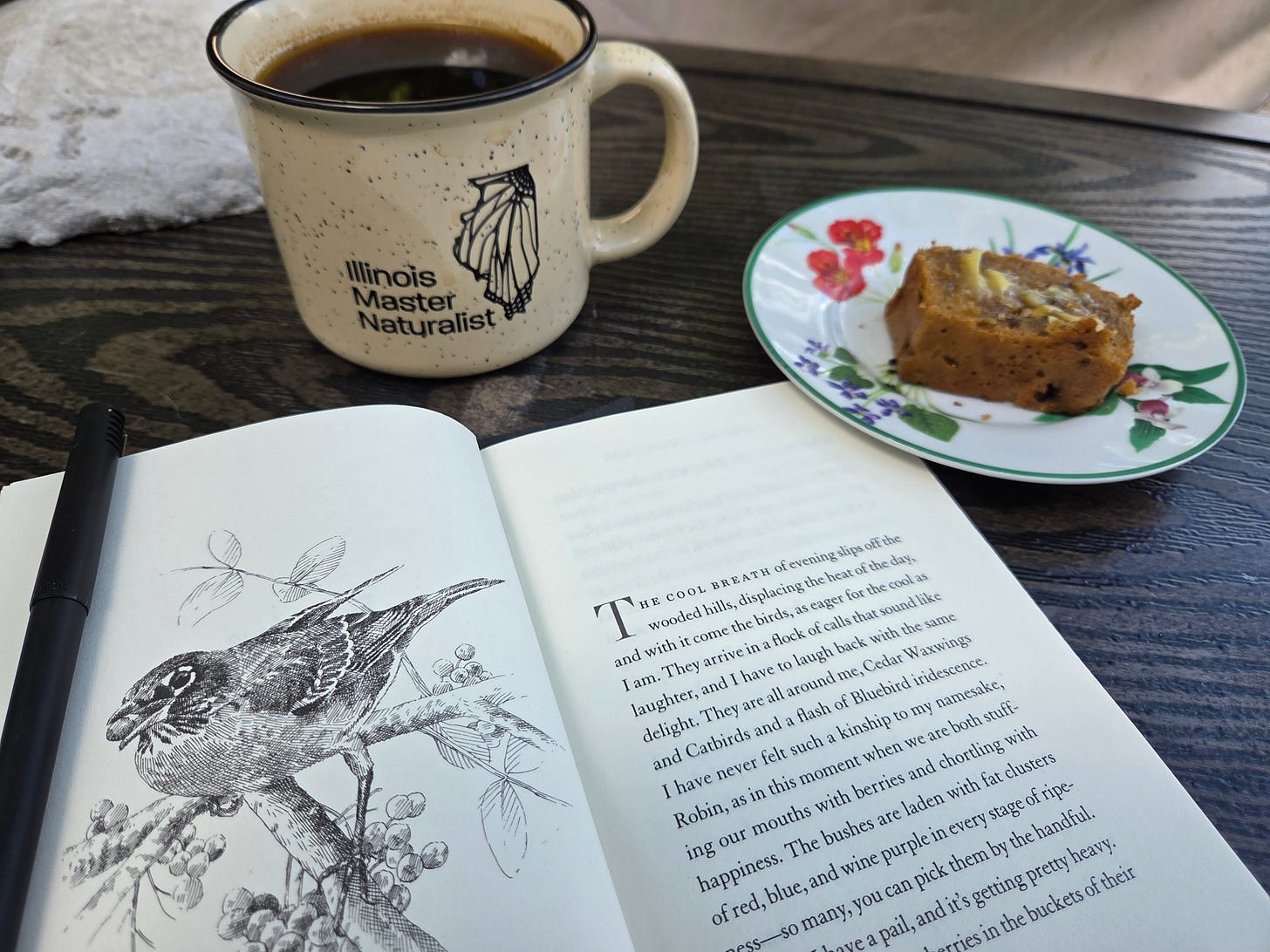 A cup of coffee, a slice of zucchini bread, and the Seriveberry book opened to the first page.