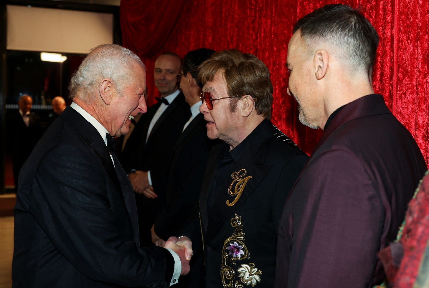 King Charles shaking hands with Elton John