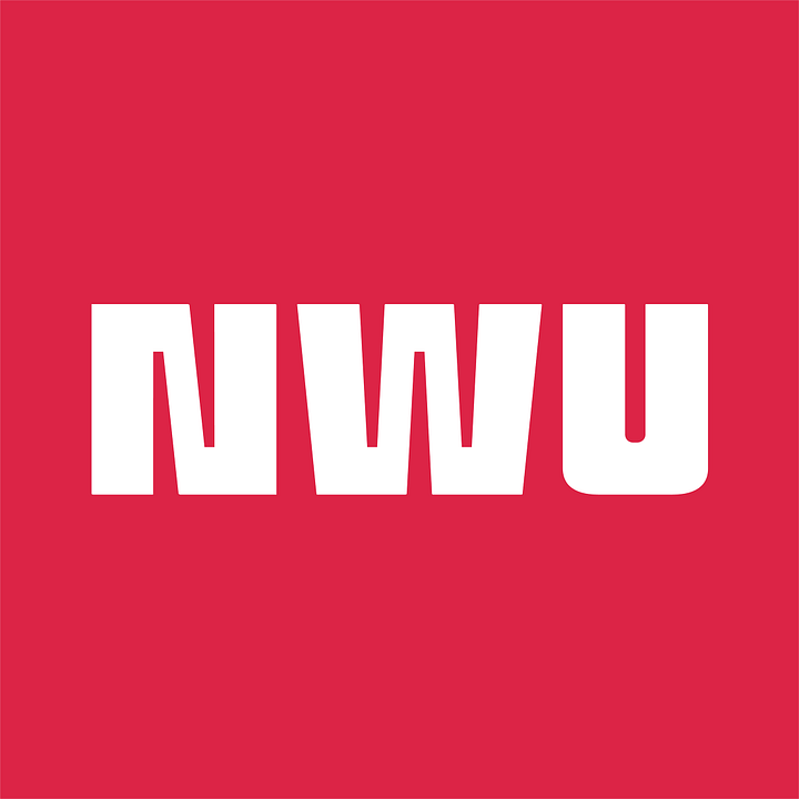 Kacey Carpenter holding National Writers Union sign and wearing a button at a writers event in Portland Oregon