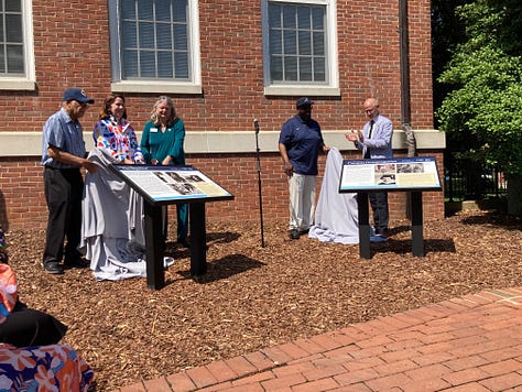 Kerry Devine, Victoria Mathews, Chris Williams, and Troy Paino unveil two new wayside panels in front of Combs Hall on the UMW campus on Tuesday, July 16.