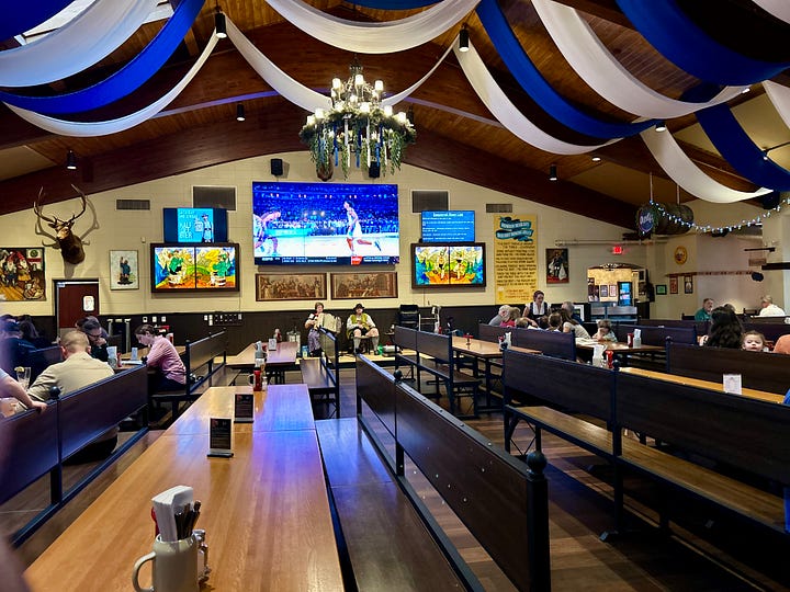 food, beer, stein, hall, tables, chairs, sign