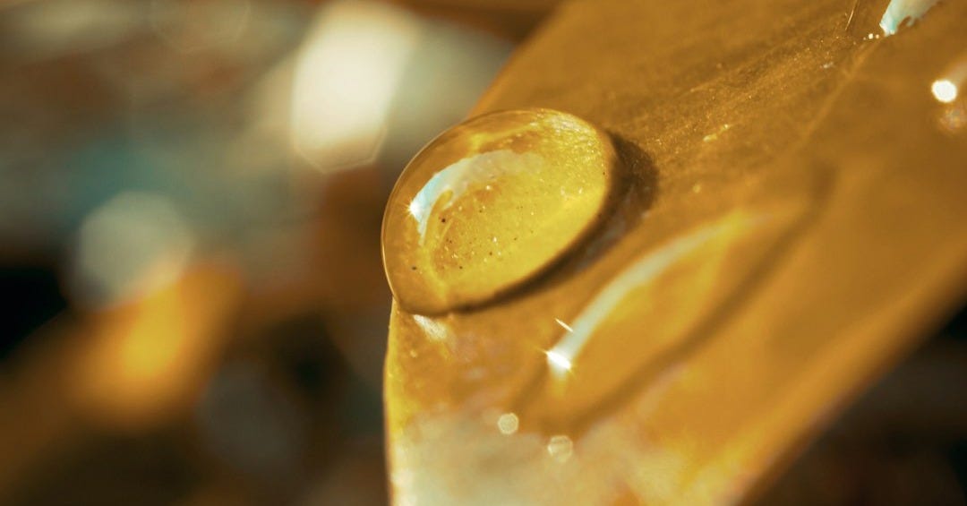 water drop on brown wooden handle water drop on brown wooden handle