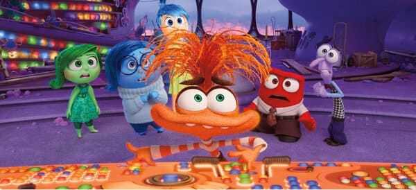 A still from Disney and Pixar’s “Inside Out 2” shows Anxiety, an orange creature wearing a striped shirt, pressing buttons on a console as Disgust, Sadness, Joy, Anger and Fear look on.