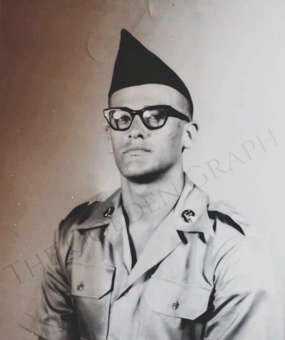 a man wearing an Army hat and uniform