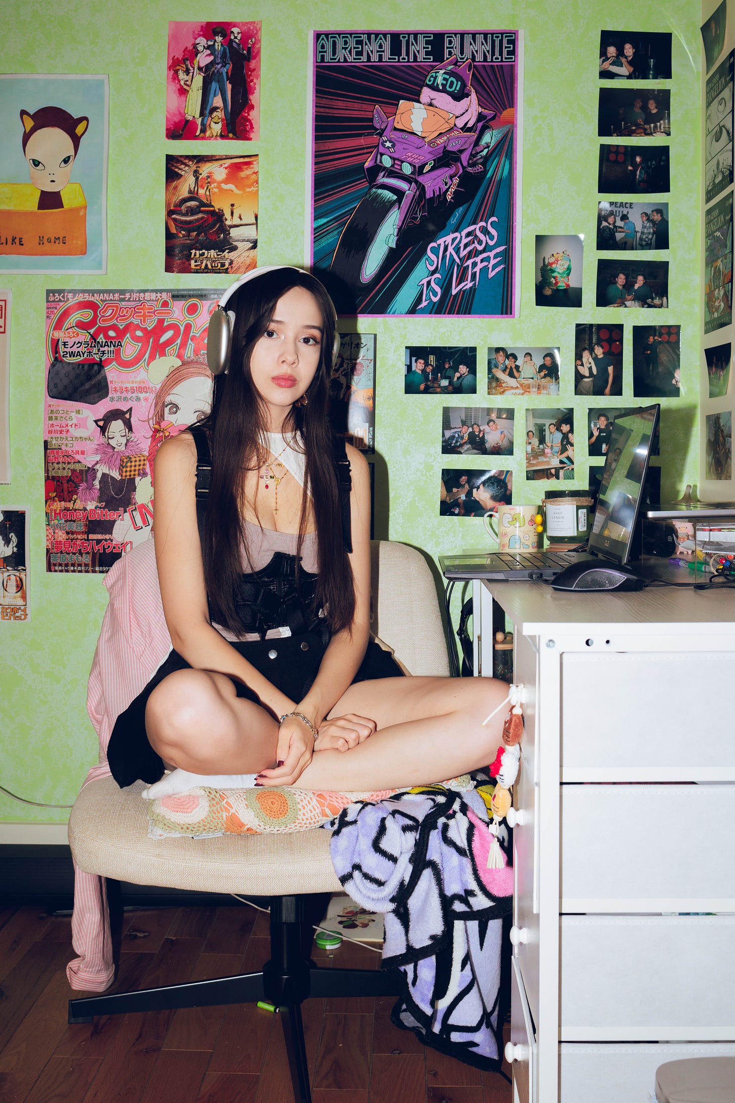 Christina Gayton sits at a computer desk with headphones on