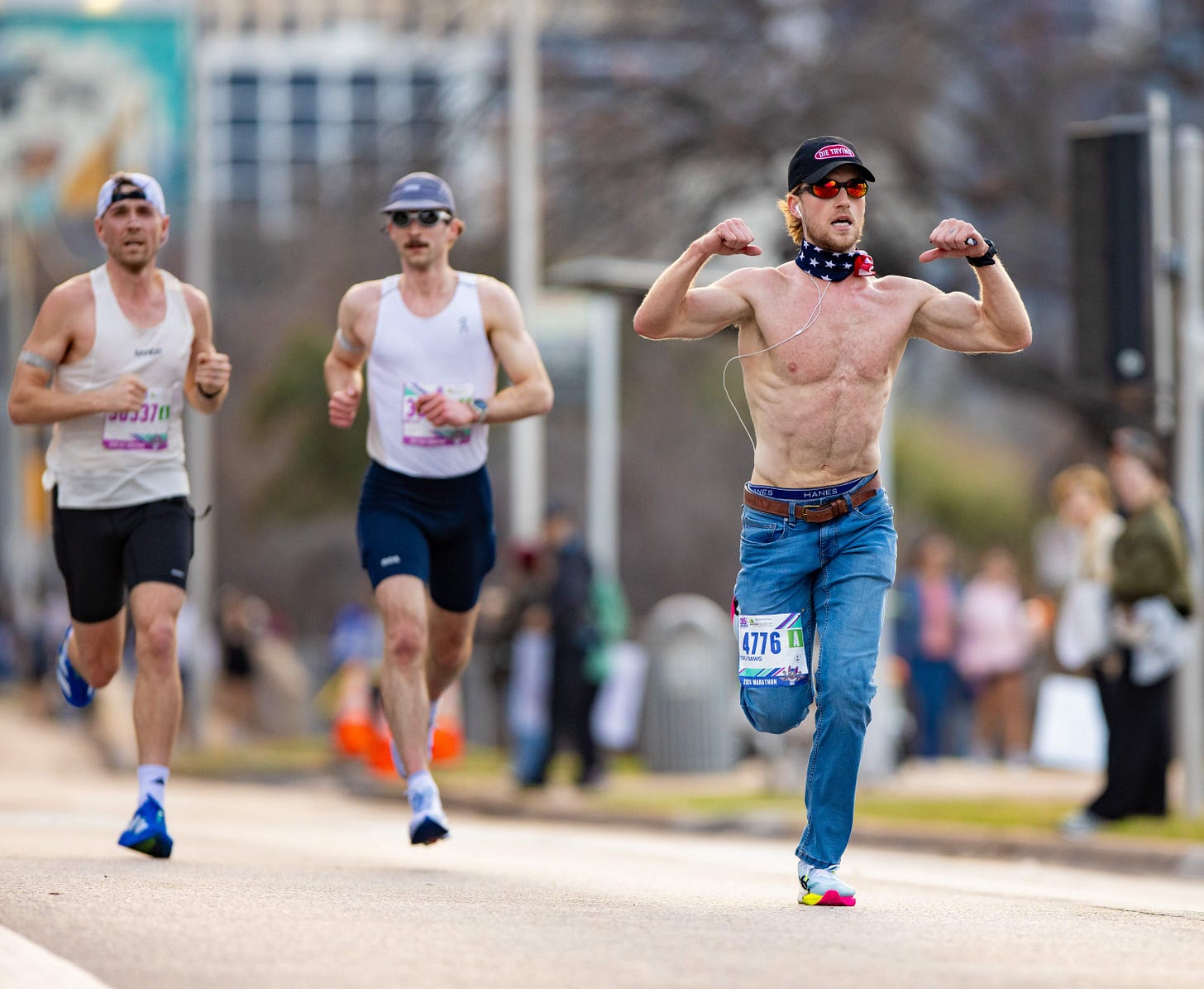 Runners participating in a race, with one individual posing confidently.