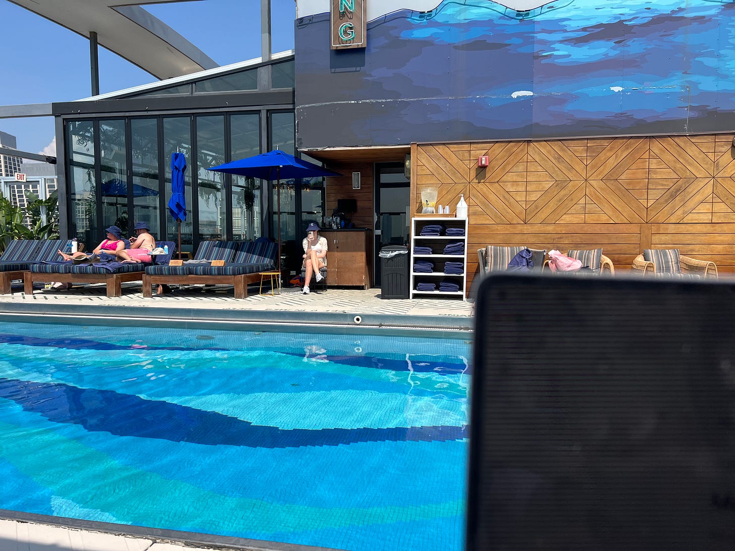 Picture of laptop screen with a pool in the background
