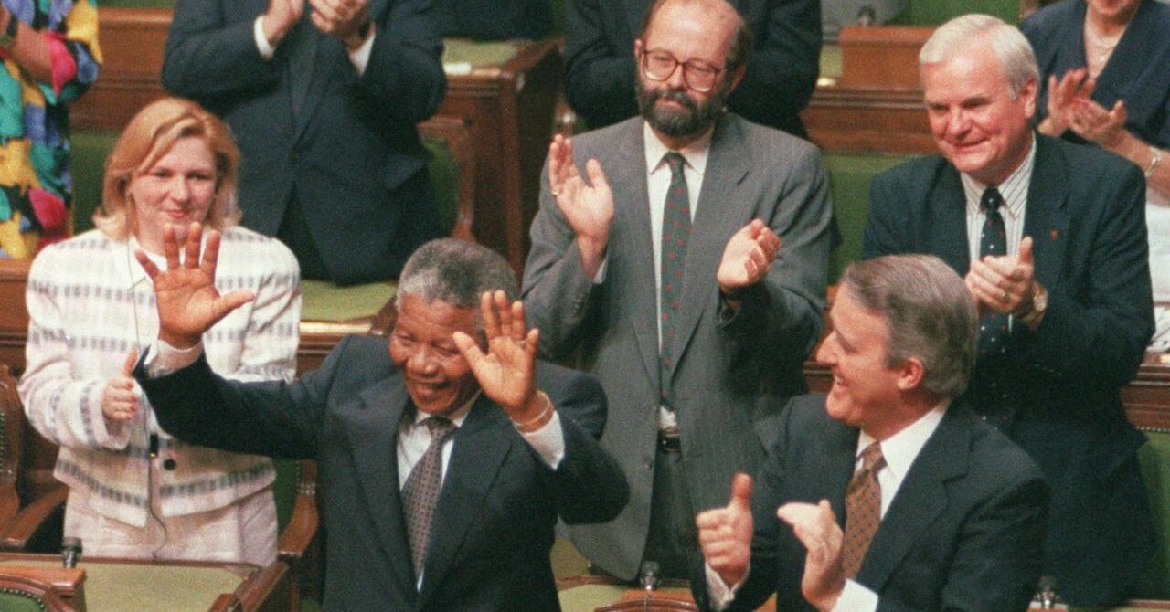 Nelson Mandela raises his arms as he is acknowledged by Prime Minister Brian Mulroney and other members of Parliament in Ottawa, June 18, 1990. Former prime minister Brian Mulroney is dead at 84. His family announced late Thursday that the former Tory leader died peacefully, surrounded by loved ones. 