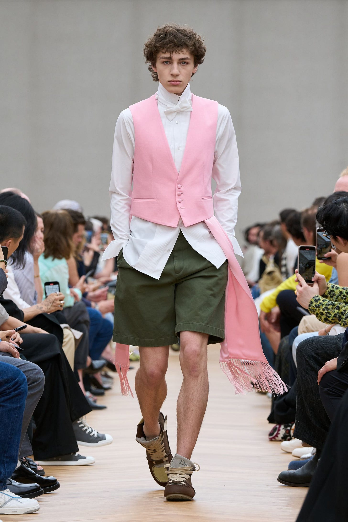 Image may contain Clothing Shorts Electronics Mobile Phone Phone Adult Person Footwear and Shoe