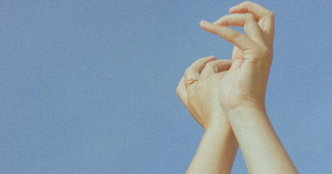 persons hand on blue sky persons hand on blue sky