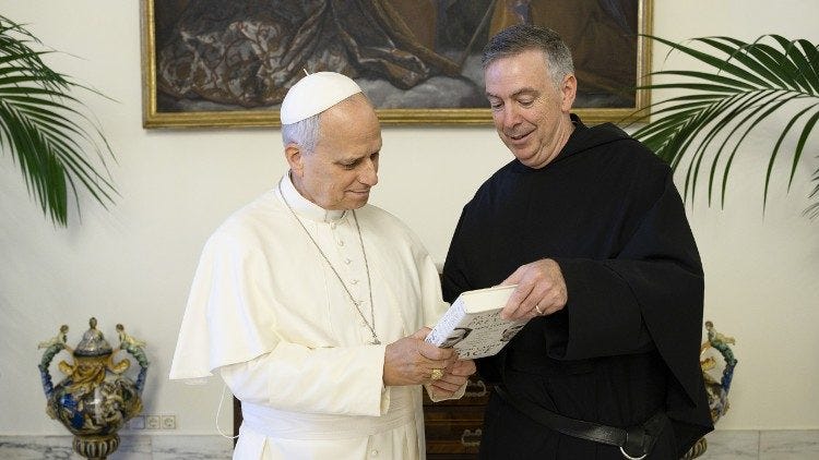 Pope Leo XIV and Fr. Joseph Farrell look at the back cover of the Pope's book Pope Leo XIV and Fr. Joseph Farrell look at the back cover of the Pope's book
