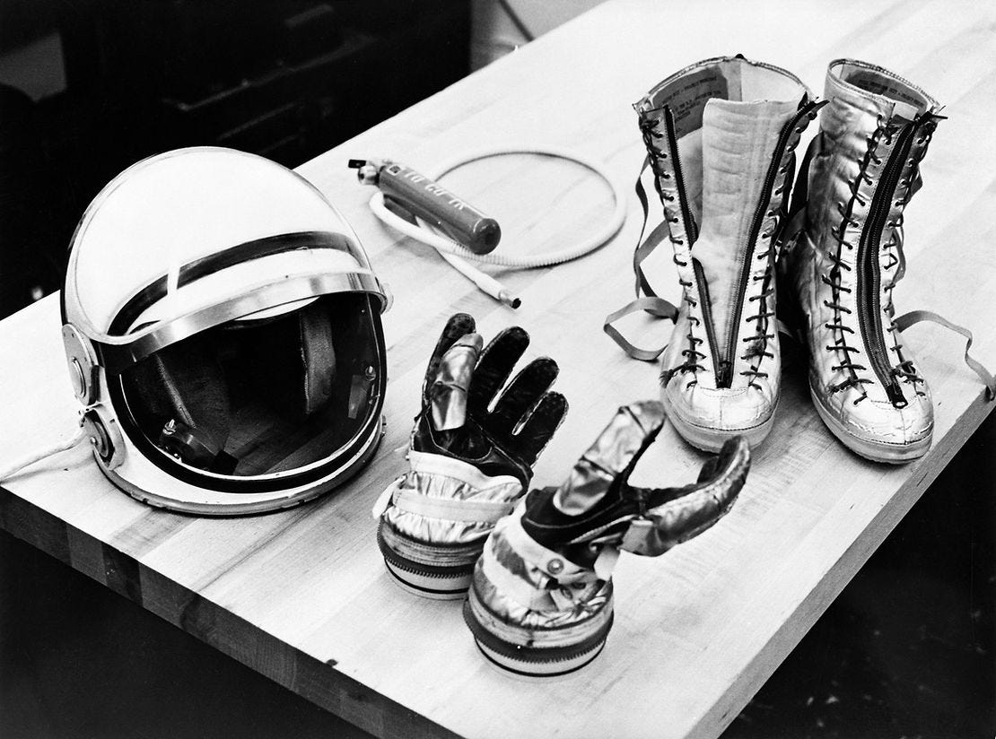 Table top view of some of the Mercury suit components including gloves, boots, and helmet; 1961 (NASA)