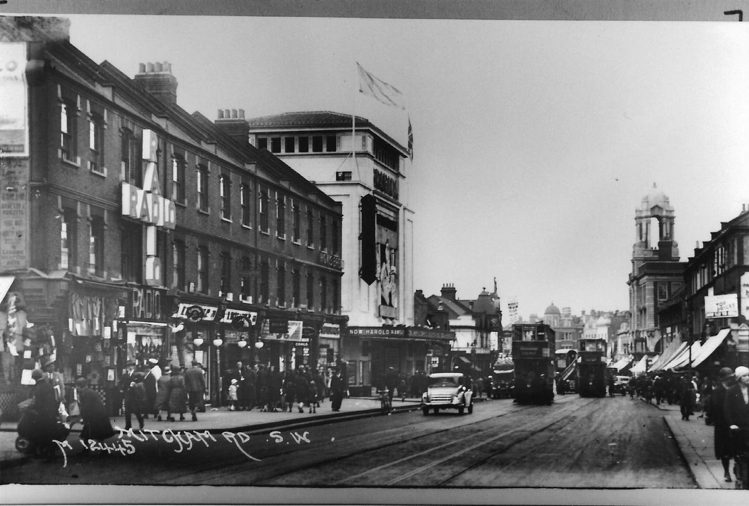 May be an image of 6 people, tram, street and text