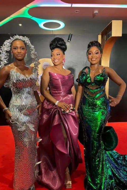 BBC/CHIMEZIE UCHEAGBO Three women pose in their dresses.
