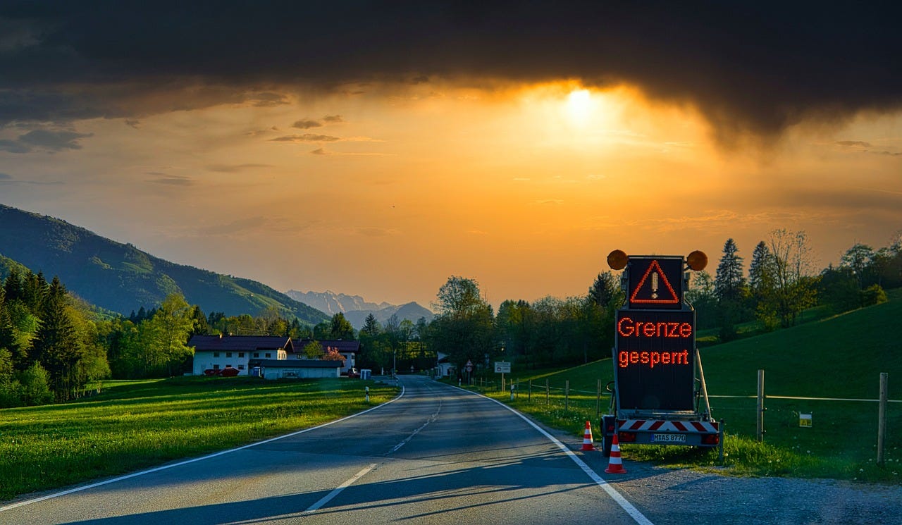 A road with a sign on it
Description automatically generated