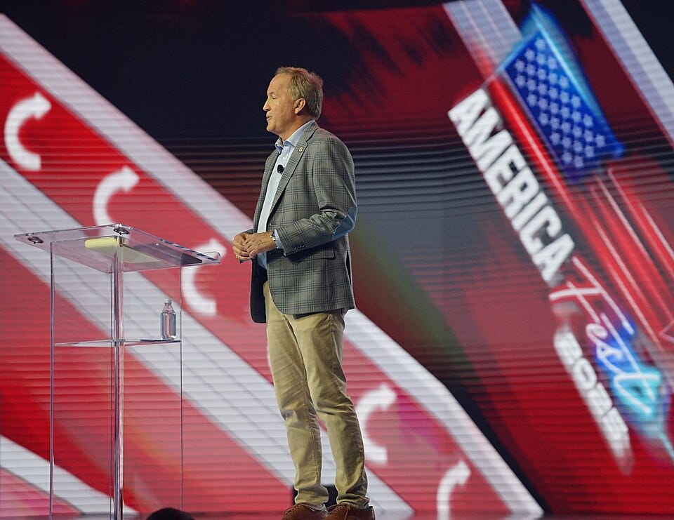 Image: Ken Paxton at AmericaFest 2025 in Phoenix, AZ (December 20, 2025) Wikimedia Commons user Xuthoria / CC BY-SA 4.0 https://commons.wikimedia.org/wiki/File:AmericaFest_2025_-_Ken_Paxton_03_(cropped).jpg. Image: Ken Paxton at AmericaFest 2025 in Phoenix, AZ (December 20, 2025) Wikimedia Commons user Xuthoria / CC BY-SA 4.0 https://commons.wikimedia.org/wiki/File:AmericaFest_2025_-_Ken_Paxton_03_(cropped).jpg.